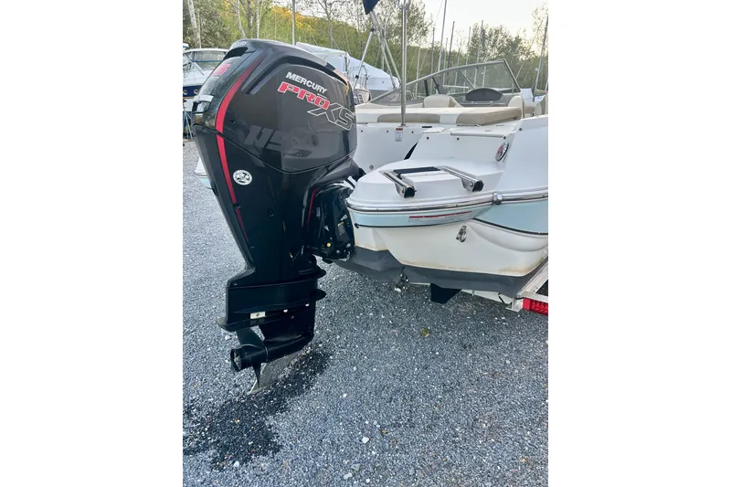Slide: The Image of 2017 Stingray 204 LR boat with Mercury Pro XS outboard motor on gravel surface. - 9
