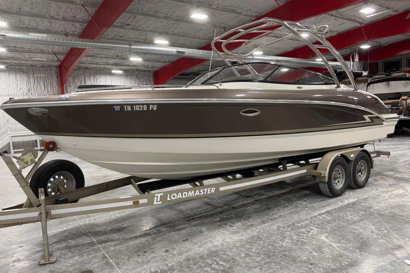 The Image of 2014 Formula 270 Bowrider boat on Loadmaster trailer in indoor storage facility. - 1