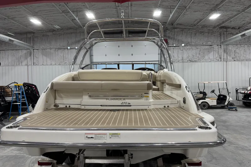 Slide: The Image of 2014 Formula 270 Bowrider boat in a warehouse, rear view with swim platform. - 4