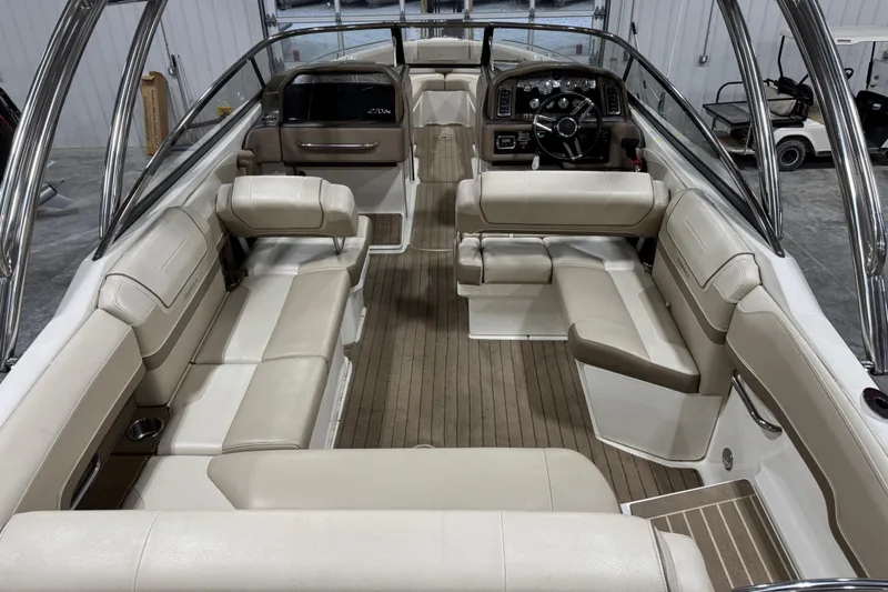 Slide: The Image of Interior of a 2014 Formula 270 Bowrider boat with beige seating and wood flooring. - 6