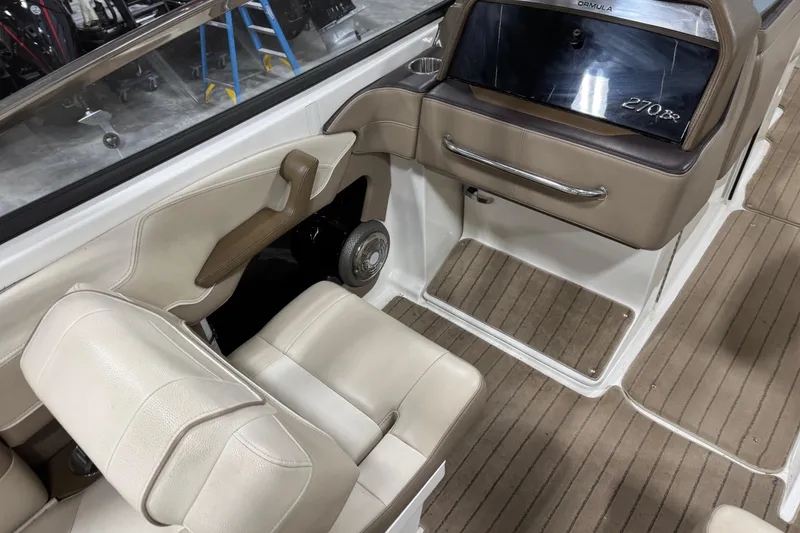 Slide: The Image of Interior of a 2014 Formula 270 Bowrider boat with beige seating and dashboard. - 9