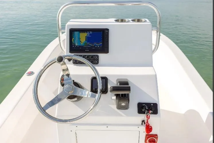 Slide: The Image of Steering console of 2026 Privateer 18 Retriever boat with navigation display and controls. - 2