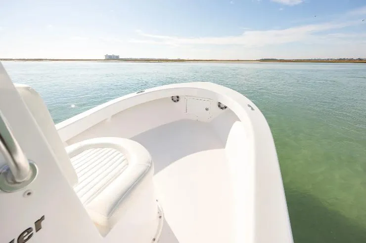 Slide: The Image of Privateer 18 Retriever 2026 boat on calm water, clear sky, and distant shoreline. - 3