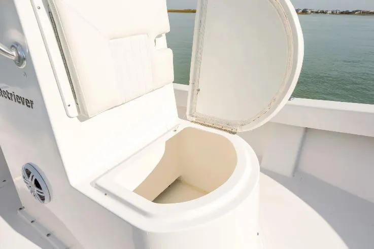 Slide: The Image of Open storage compartment on 2026 Privateer 18 Retriever boat, with ocean view. - 4