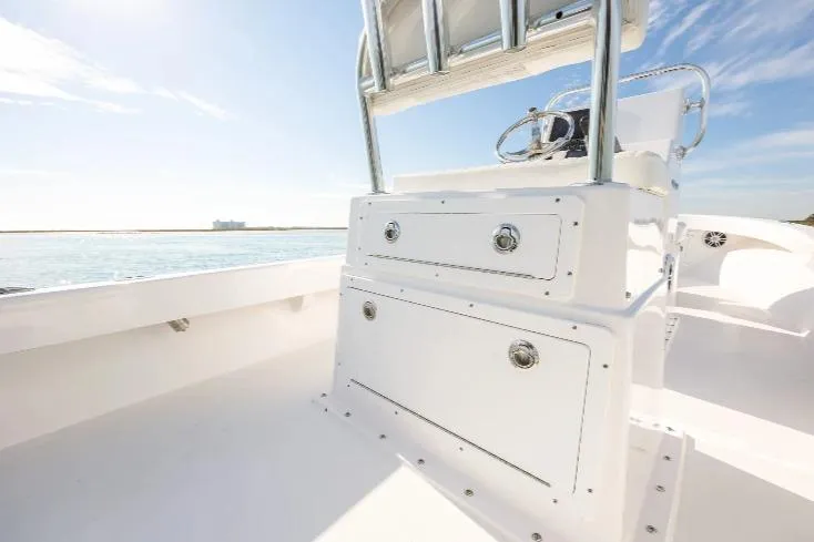 Slide: The Image of 2026 Privateer 18 Retriever boat interior with sleek white console and ocean view. - 8