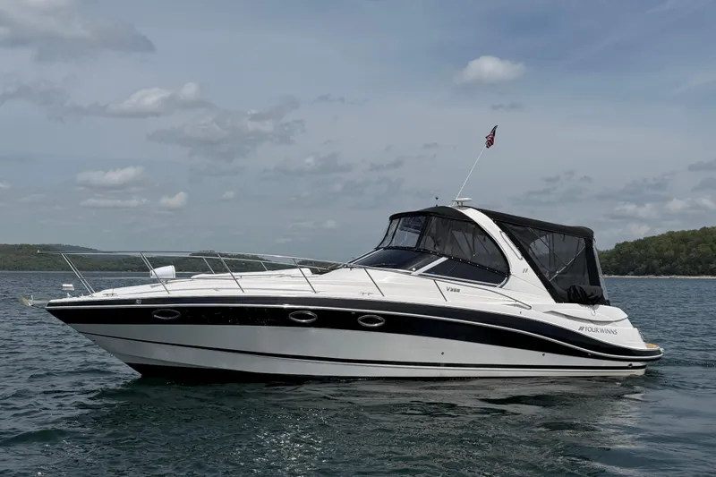 The Image of 2009 Four Winns V358 boat on calm water under a cloudy sky. - 1