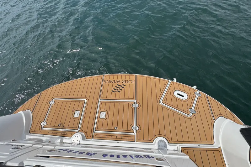 Slide: The Image of 2009 Four Winns V358 boat deck with teak finish on water. - 11