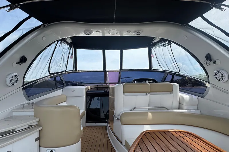 Slide: The Image of Interior view of 2009 Four Winns V358 boat with luxurious seating and wooden table. - 12