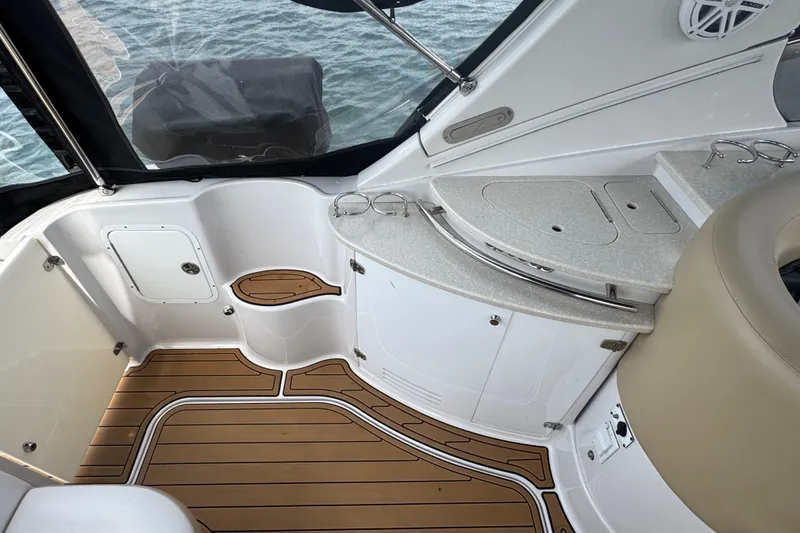 Slide: The Image of 2009 Four Winns V358 boat interior with sleek countertops and wood-patterned flooring. - 13