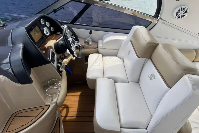 Slide: The Image of 2009 Four Winns V358 boat interior with leather seating and modern dashboard controls. - 17