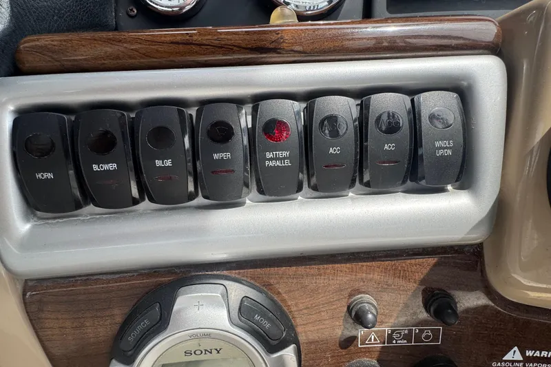 Slide: The Image of Control panel of a 2009 Four Winns V358 boat with labeled switches. - 20