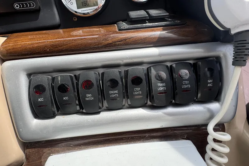 Slide: The Image of Control panel of a 2009 Four Winns V358 boat with labeled switches. - 21