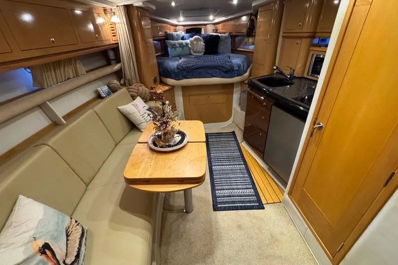 Slide: The Image of Luxurious 2009 Four Winns V358 yacht interior with cozy seating, kitchenette, and elegant decor. - 22