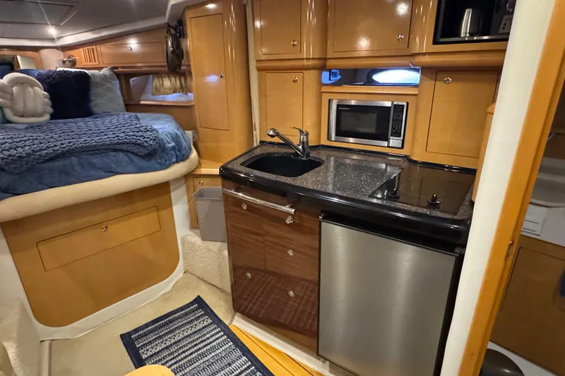 Slide: The Image of 2009 Four Winns V358 yacht interior with kitchenette and cozy sleeping area. - 28