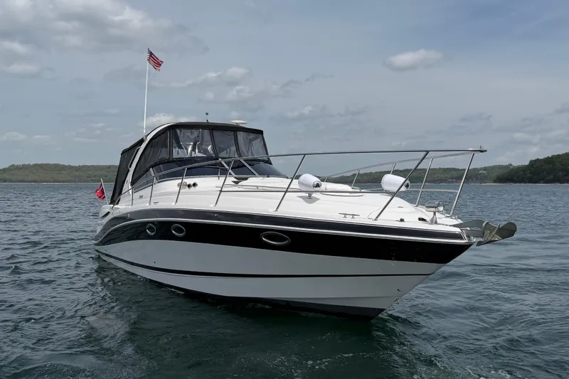 Slide: The Image of 2009 Four Winns V358 boat on a lake, featuring sleek design and American flag. - 3