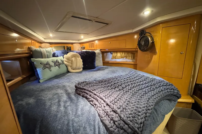 Slide: The Image of Luxurious cabin interior of 2009 Four Winns V358 yacht with cozy bedding and ambient lighting. - 32