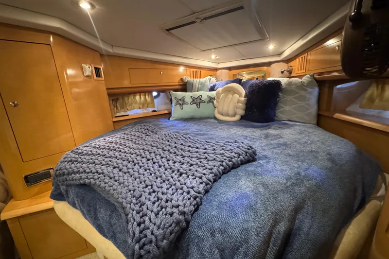 Slide: The Image of Luxurious cabin interior of 2009 Four Winns V358 yacht with cozy bedding and ambient lighting. - 33