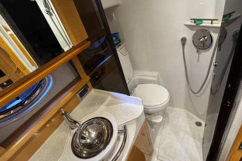 Slide: The Image of 2009 Four Winns V358 yacht bathroom with sink, toilet, and shower. - 35