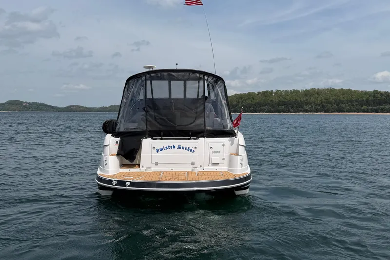 Slide: The Image of 2009 Four Winns V358 boat on water, rear view with canopy and American flag. - 6