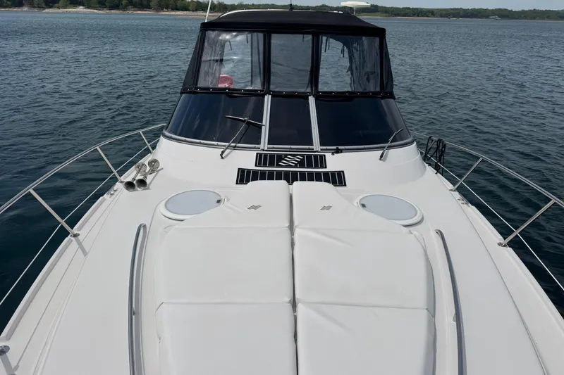 Slide: The Image of 2009 Four Winns V358 boat on calm water, featuring sleek design and spacious deck. - 9