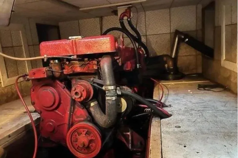 Slide: The Image of Engine room of a 1981 Marine Trader TRUNK CABIN with visible red engine components. - 13