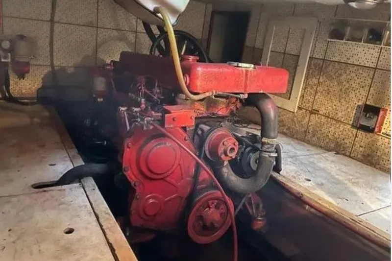 Slide: The Image of Engine room of 1981 Marine Trader TRUNK CABIN with visible red engine components. - 4