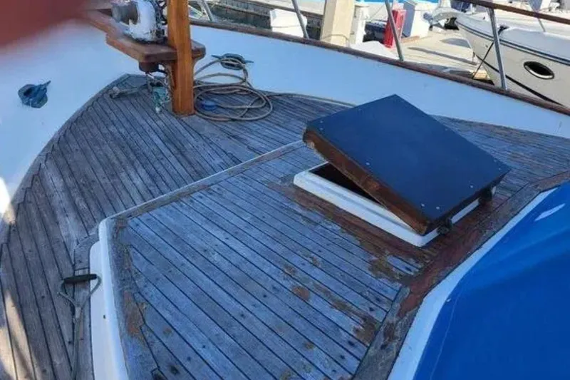 Slide: The Image of 1981 Marine Trader TRUNK CABIN boat deck with open hatch and wooden flooring. - 8