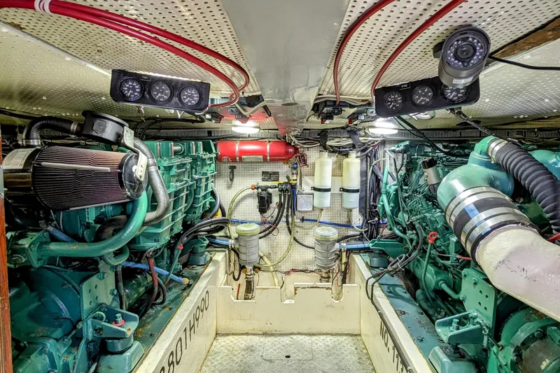 Slide: The Image of Engine room of a 1990 Neptunus Sedan 148, showcasing dual engines and mechanical components. - 12