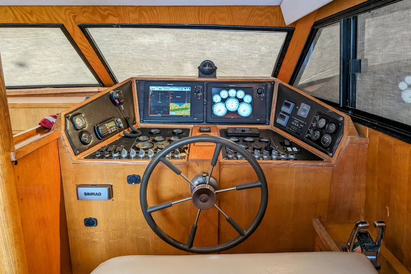 Slide: The Image of 1990 Neptunus Sedan 148 boat cockpit with steering wheel and navigation instruments. - 27