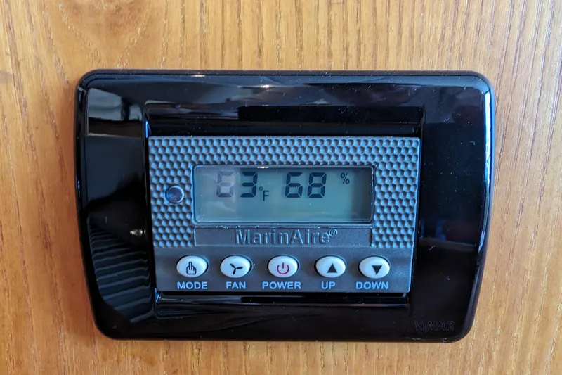 Slide: The Image of Digital thermostat displaying 63°F and 68% humidity on wooden panel. - 30