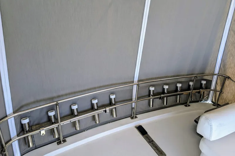 Slide: The Image of Interior of 1990 Neptunus Sedan 148 boat with rod holders and seating. - 33