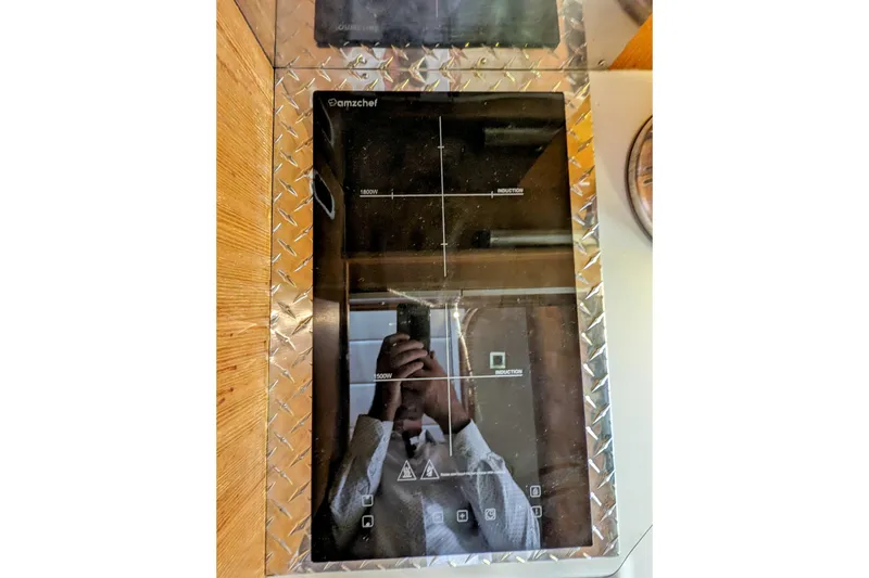 Slide: The Image of Reflection on Amzchef induction cooktop with diamond plate trim, inside a Neptunus Sedan 148. - 34