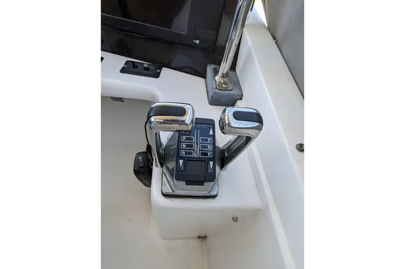 Slide: The Image of Control panel of a 1990 Neptunus Sedan 148 boat with dual levers. - 38