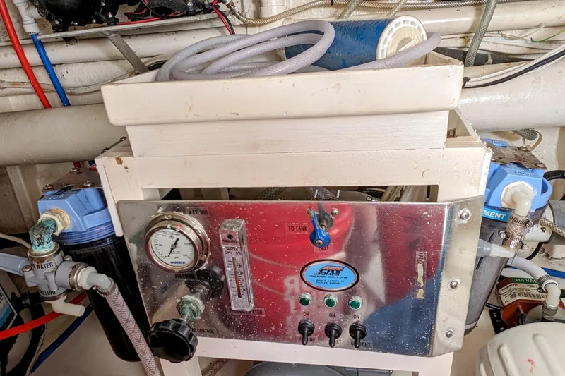 Slide: The Image of Engine room equipment in a 1990 Neptunus Sedan 148 yacht, featuring gauges and control switches. - 39