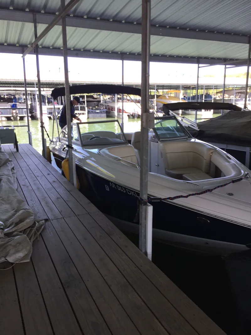 Slide: The Image of 2011 Cobalt 242 boat docked under covered marina. - 3