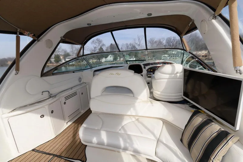 Slide: The Image of 1999 Sea Ray 380 Sundancer interior with white seating and modern amenities. - 12