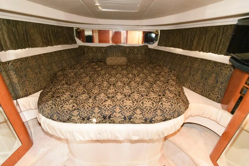 Slide: The Image of Luxurious cabin interior of 1999 Sea Ray 380 Sundancer with patterned bedding. - 17