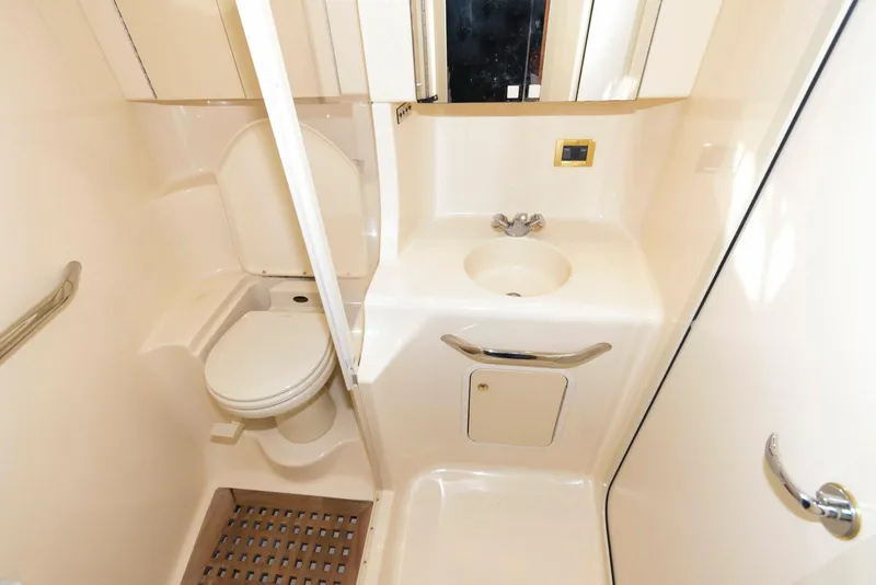Slide: The Image of 1999 Sea Ray 380 Sundancer bathroom with toilet, sink, and shower area. - 19