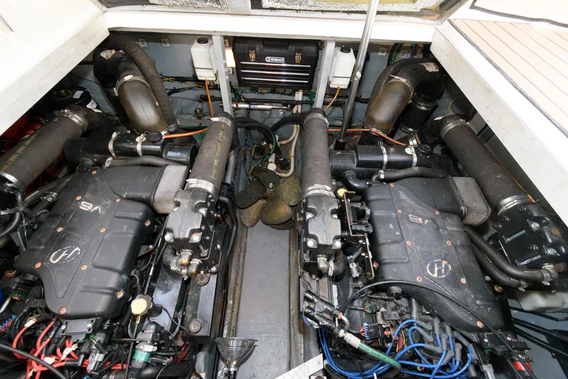 Slide: The Image of Engine room of a 1999 Sea Ray 380 Sundancer with dual engines and mechanical components. - 20