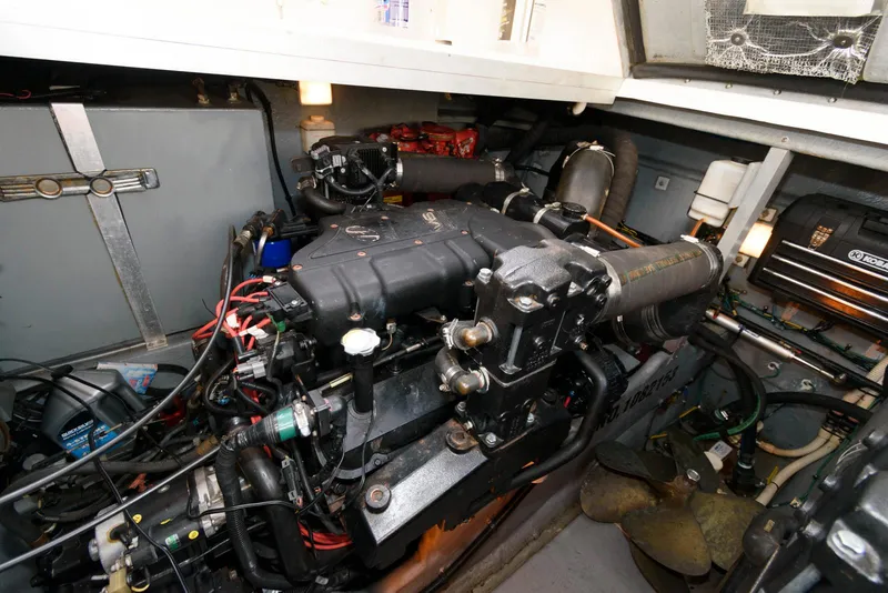 Slide: The Image of Engine room of 1999 Sea Ray 380 Sundancer, showcasing mechanical components and wiring. - 21