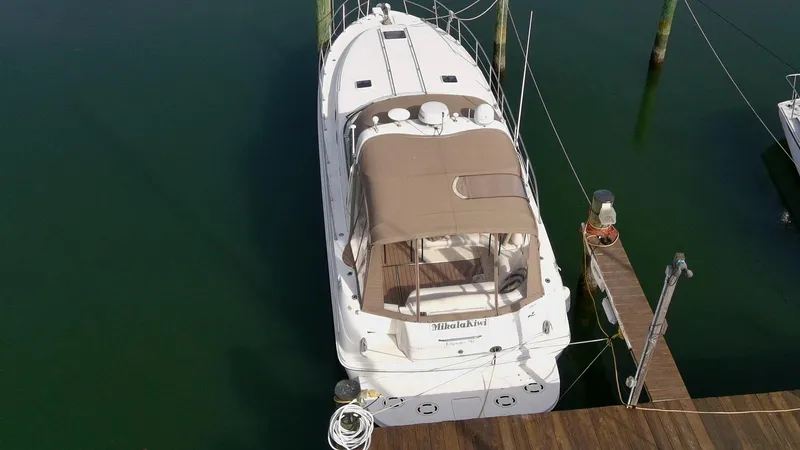 Slide: The Image of 1999 Sea Ray 380 Sundancer docked at a marina, aerial view. - 4