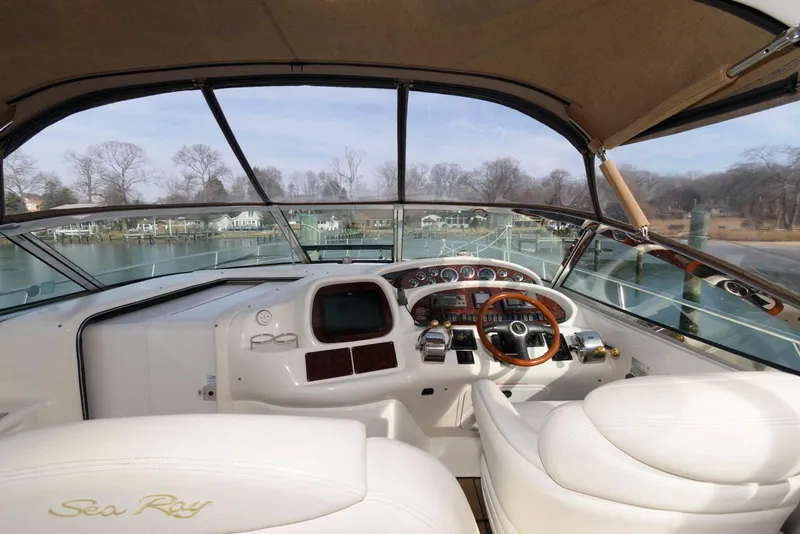 Slide: The Image of Cockpit of 1999 Sea Ray 380 Sundancer yacht with steering wheel and dashboard controls. - 7