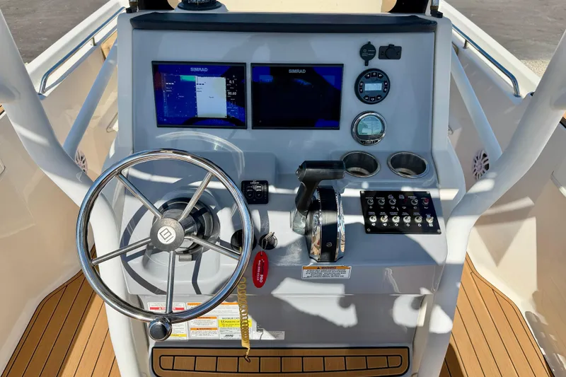 Slide: The Image of 2023 Bayliner Trophy T24CC helm with dual Simrad displays and modern controls. - 11