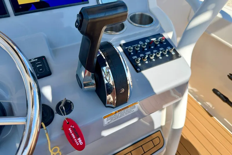 Slide: The Image of Control panel of 2023 Bayliner Trophy T24CC boat with throttle and switches. - 13