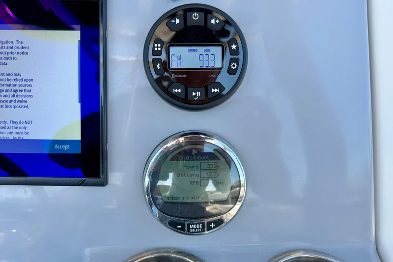 Slide: The Image of Dashboard of 2023 Bayliner Trophy T24CC with digital displays and controls. - 16