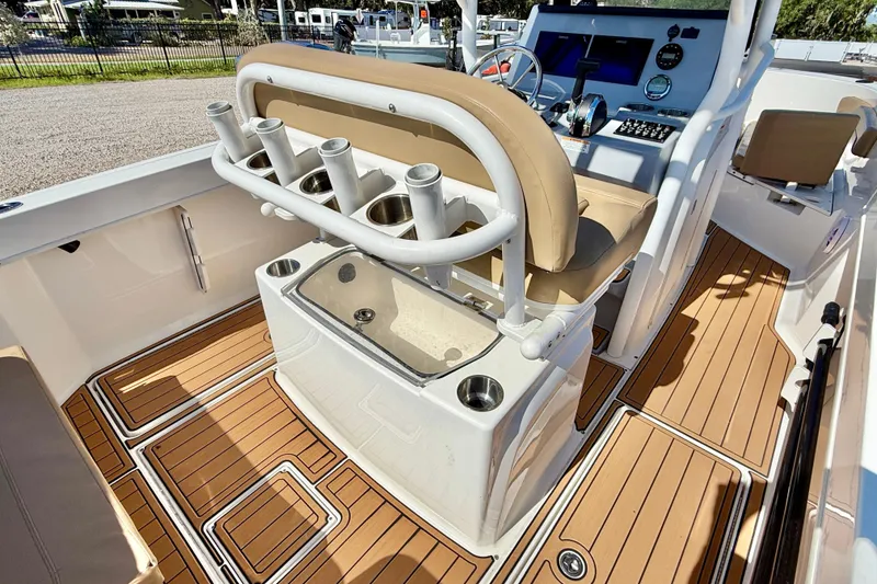 Slide: The Image of 2023 Bayliner Trophy T24CC boat interior with rod holders and teak flooring. - 20