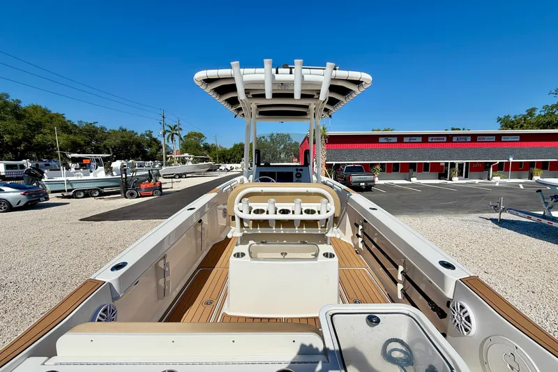 Slide: The Image of 2023 Bayliner Trophy T24CC boat with center console, docked in a sunny marina. - 21