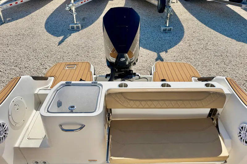 Slide: The Image of 2023 Bayliner Trophy T24CC boat interior with seating and motor, showcasing modern design. - 31