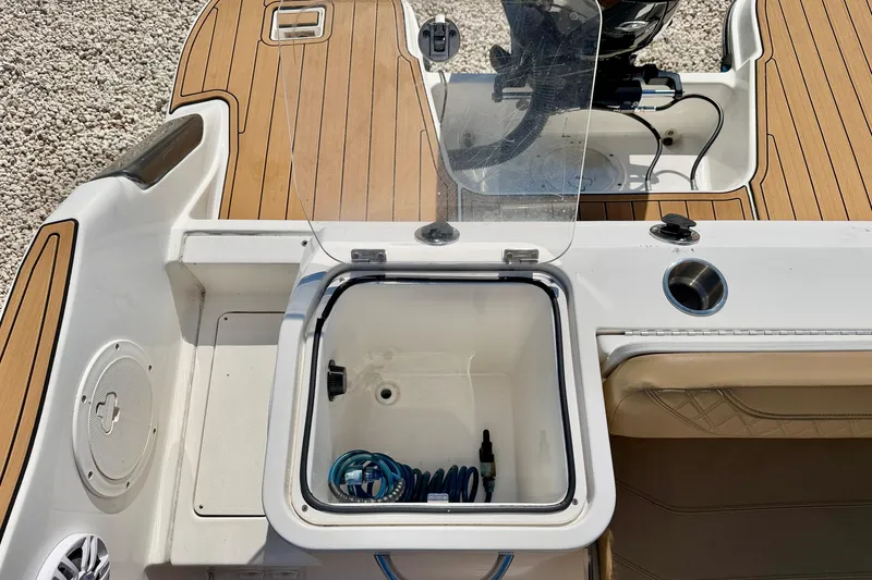 Slide: The Image of 2023 Bayliner Trophy T24CC boat deck with storage compartment and seating. - 32