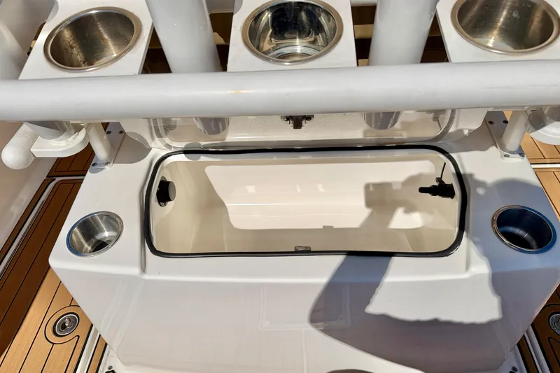 Slide: The Image of 2023 Bayliner Trophy T24CC boat deck with rod holders and storage compartment. - 33